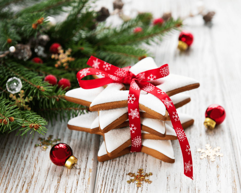 Christmas Cookies tied in a red ribbon near some evergreen branches